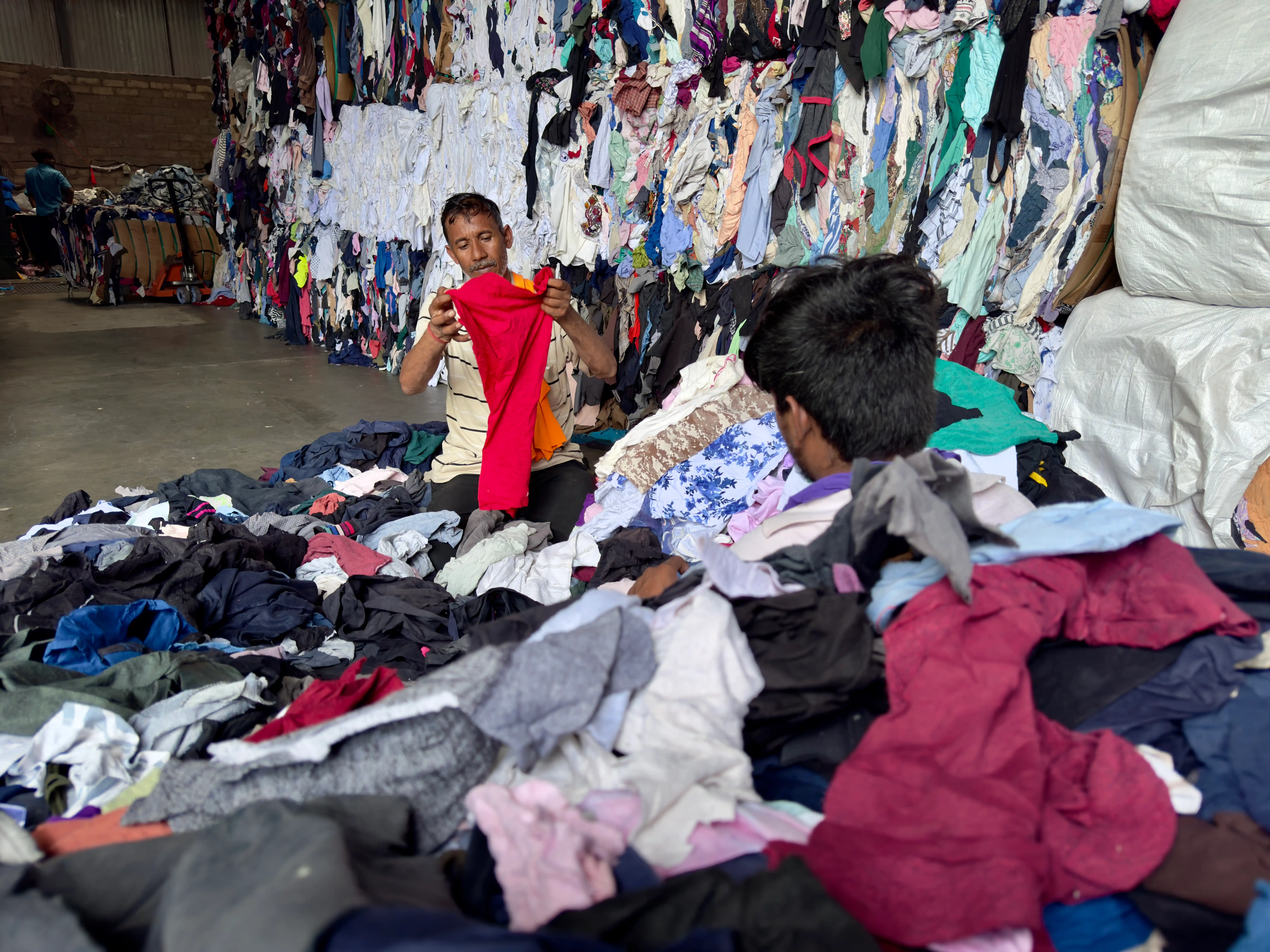 clothing being sorted to cut for clippings