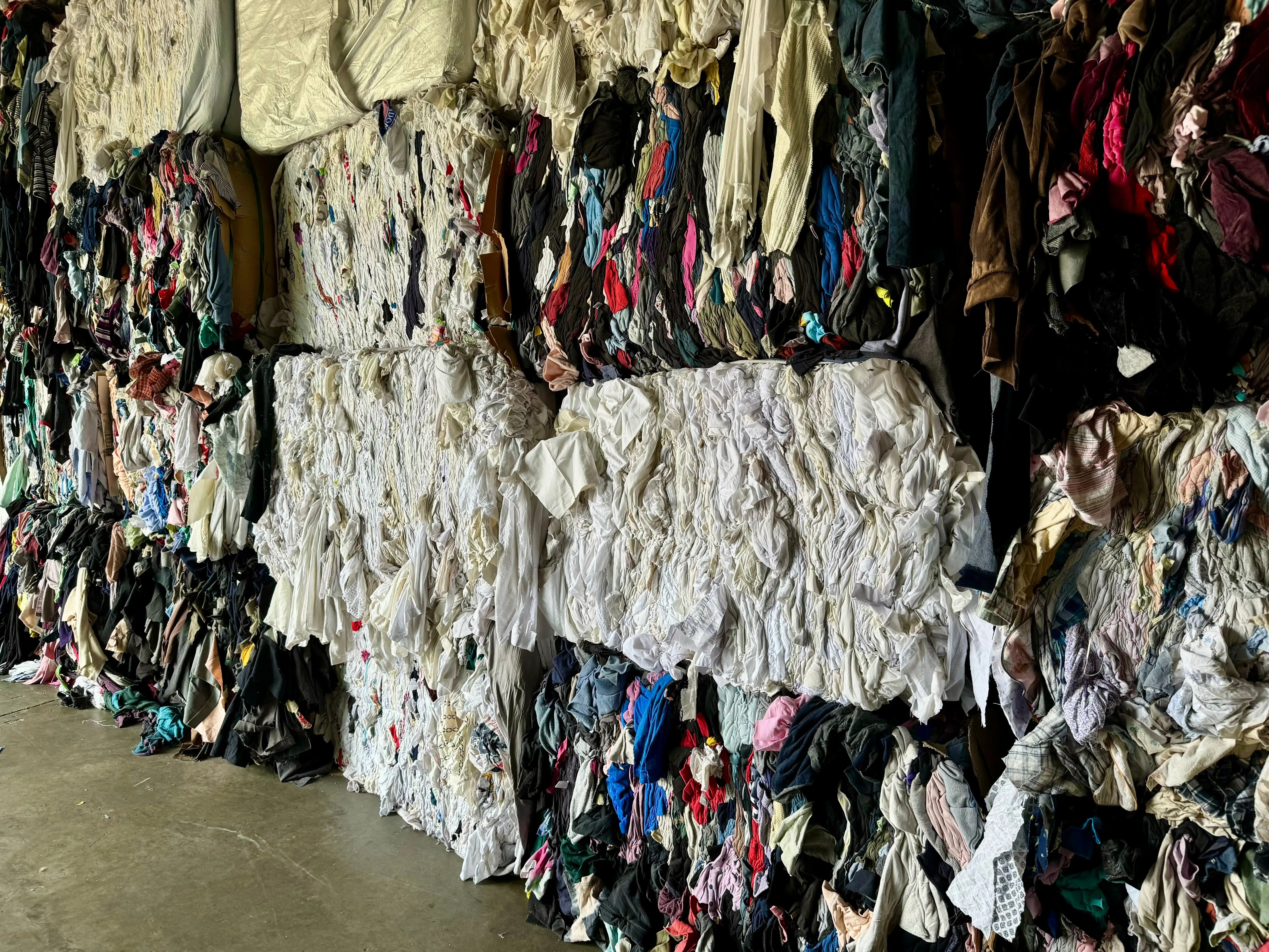 a big lot of used clothing ready to cut for clippings