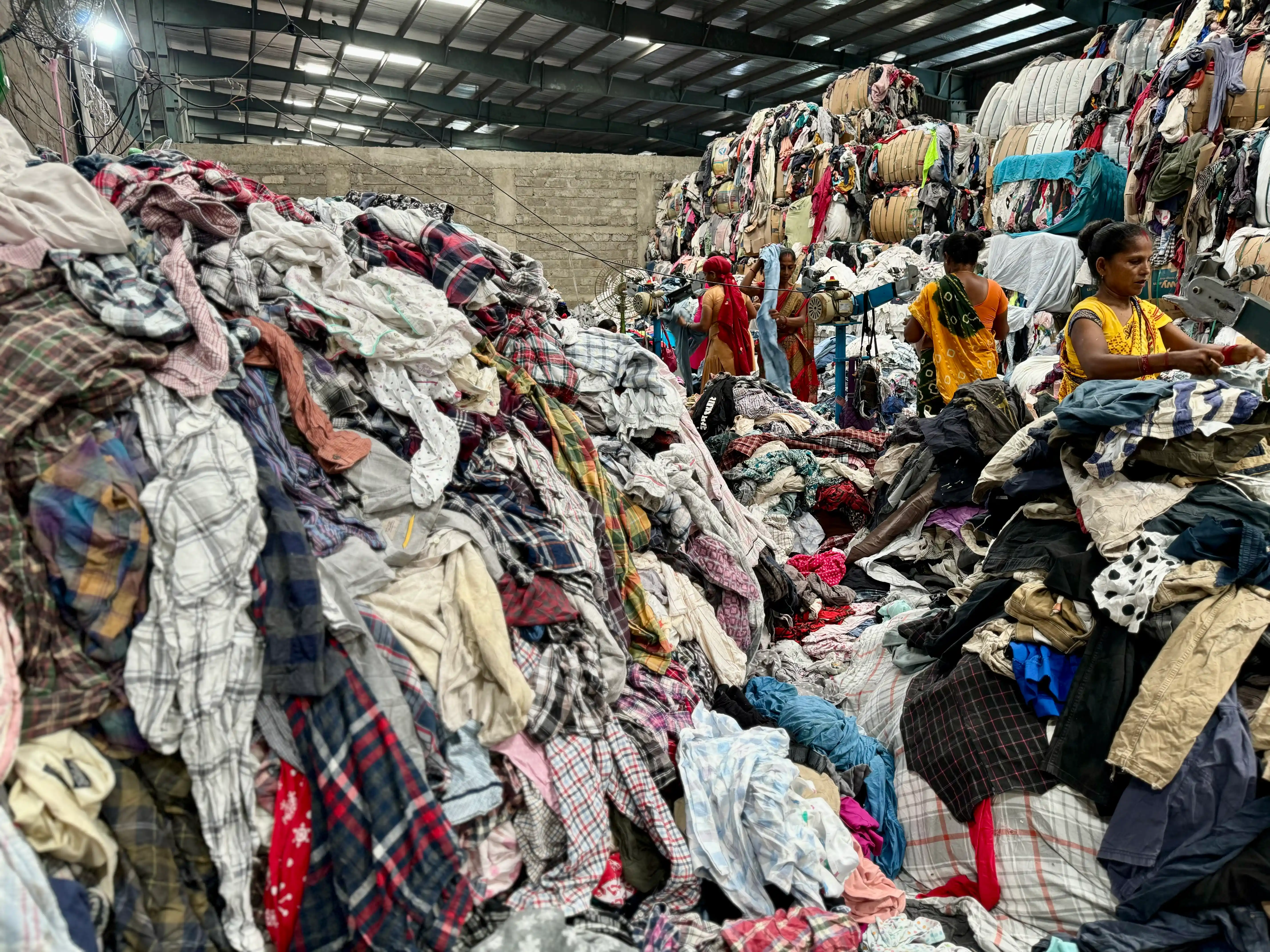 huge pile of clothing ready to cut